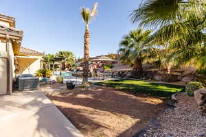 View of yard with an outdoor pool, a patio, and central AC unit