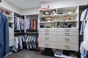 Spacious closet featuring carpet floors