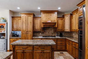 Kitchen featuring appliances with stainless steel finishes, recessed lighting, and decorative backsplash