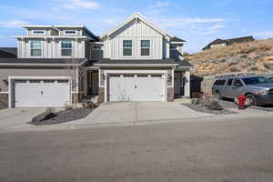 View of front of house with a garage, driveway, and board and batten siding