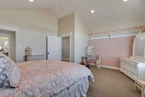 Carpeted bedroom with high vaulted ceiling, recessed lighting, and baseboards