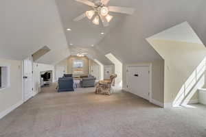 Additional living space with carpet, ceiling fan, lofted ceiling, and baseboards