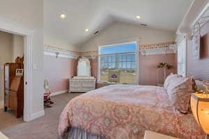 Carpeted bedroom with lofted ceiling, recessed lighting, visible vents, and baseboards