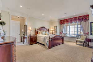 Bedroom with ornamental molding, recessed lighting, light carpet, and baseboards