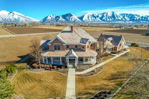 View of front facade featuring a mountain view, a porch, and a front yard