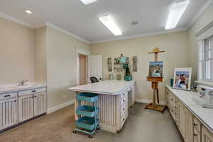 Kitchen with light carpet, light countertops, a peninsula, and a sink