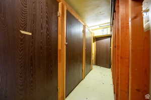 Corridor with a textured ceiling and concrete flooring