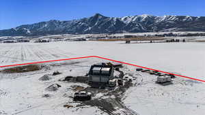 Snowy aerial view featuring a mountain view