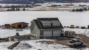 View of front facade with a garage, a mountain view, and driveway