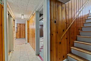 Hallway with stairs and wooden walls