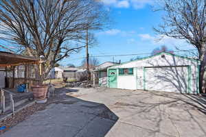 Exterior space featuring a garage, an outdoor structure, and fence