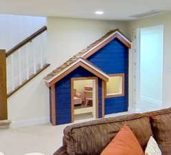 Interior space with carpet floors, recessed lighting, visible vents, and baseboards