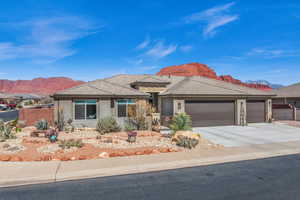 View of front of home featuring an attached garage, fence, and a mountain view