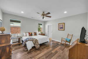 Bedroom featuring baseboards, visible vents, wood finished floors, and recessed lighting