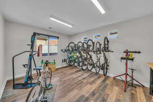 Exercise area featuring wood finished floors, visible vents, and baseboards