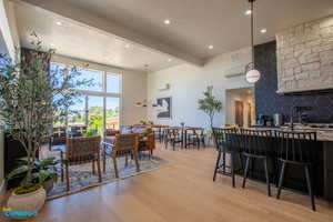 The open kitchen and living room concept with a dining area, and large windows that lead to the deck.