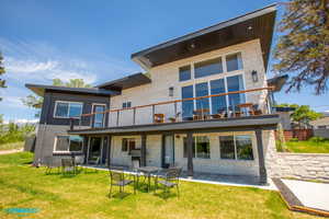 Side view of the home where the deck, patio, and separate entrance to the ADU are located.