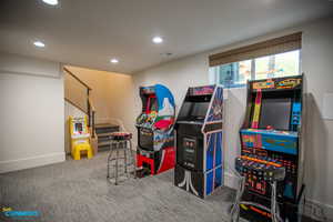 At the base of the stairway leading into the basement you will find the recreation room with arcade games.