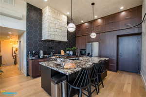 Fully stocked kitchen with kitchen island, tons of storage, appliances, and the door leading to the 2 car garage.