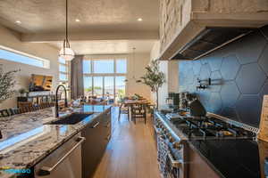 View from the kitchen into the living room and large windows.