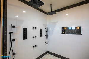 View the details of the tub/shower combo which features multiple shower heads and jets.