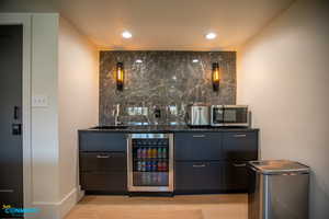 Details of the wet bar located in the living room. You can see the locked owners closet on the left side that holds all consumable supplies.