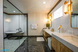 The amazing ensuite master bathroom with his and her sinks, a luxurious tub/shower combo.