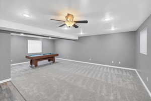 Playroom featuring billiards, a textured ceiling, baseboards, and a ceiling fan