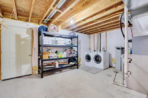 Unfinished basement featuring washer and clothes dryer