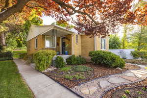 View of front of house with brick siding and a porch