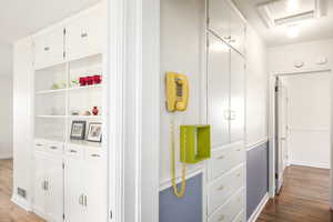 Corridor featuring visible vents, light wood-style flooring, and baseboards