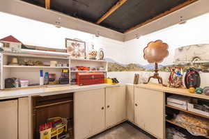 Interior space with concrete flooring, light countertops, a mountain view, and open shelves