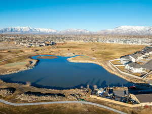 Drone / aerial view featuring a water and mountain view