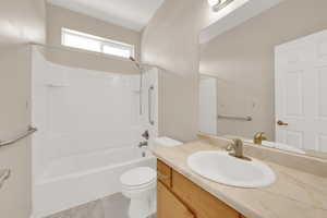 Full bathroom with washtub / shower combination, vanity, and toilet