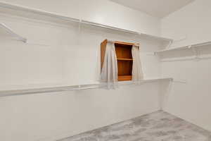 Spacious closet featuring marble finish floor