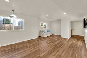 Unfurnished room featuring light wood finished floors, recessed lighting, and baseboards