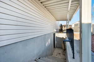 View of side of home featuring an outdoor structure