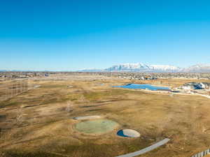 Birds eye view of property with a water and mountain view