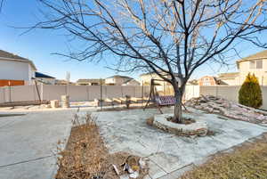 View of yard featuring a patio area, a fenced backyard, and a residential view