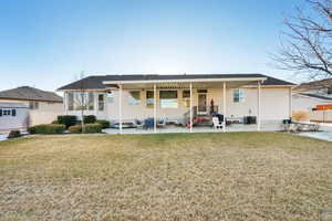 Back of property featuring a patio, a yard, cooling unit, and fence