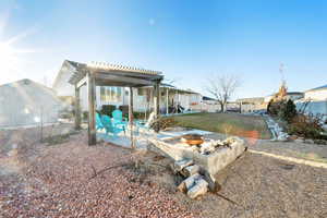 View of yard featuring an outdoor fire pit, a patio, a residential view, and a pergola