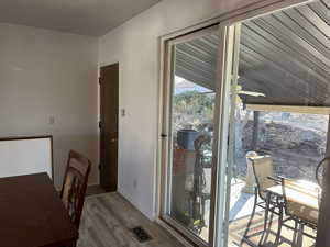 Dining area featuring visible vents, baseboards, and wood finished floors