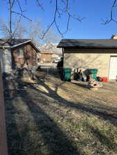 Exterior space featuring brick siding, fence, and a gate