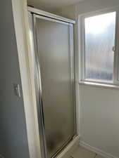 Bathroom with a shower stall and a textured ceiling