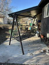 View of patio featuring a storage shed, outdoor dining space, a ceiling fan, and an outbuilding