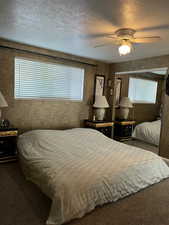 Bedroom featuring a textured ceiling and ceiling fan