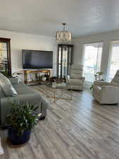 Living area with a textured ceiling and wood finished floors