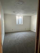 Unfurnished room with baseboards and carpet flooring