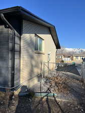 View of home's exterior featuring fence and brick siding