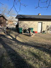 Exterior space with a gate, brick siding, fence, and a patio